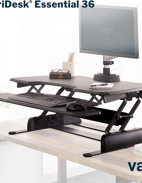 Load image into Gallery viewer, - desk Essential 36 - Two-Tier Standing Desk Converter for Monitor &amp; Accessories - Height Adjustable Sit Stand Desk - Fully Assembled Monitor Riser for Home Office - 36" Wide, Black
